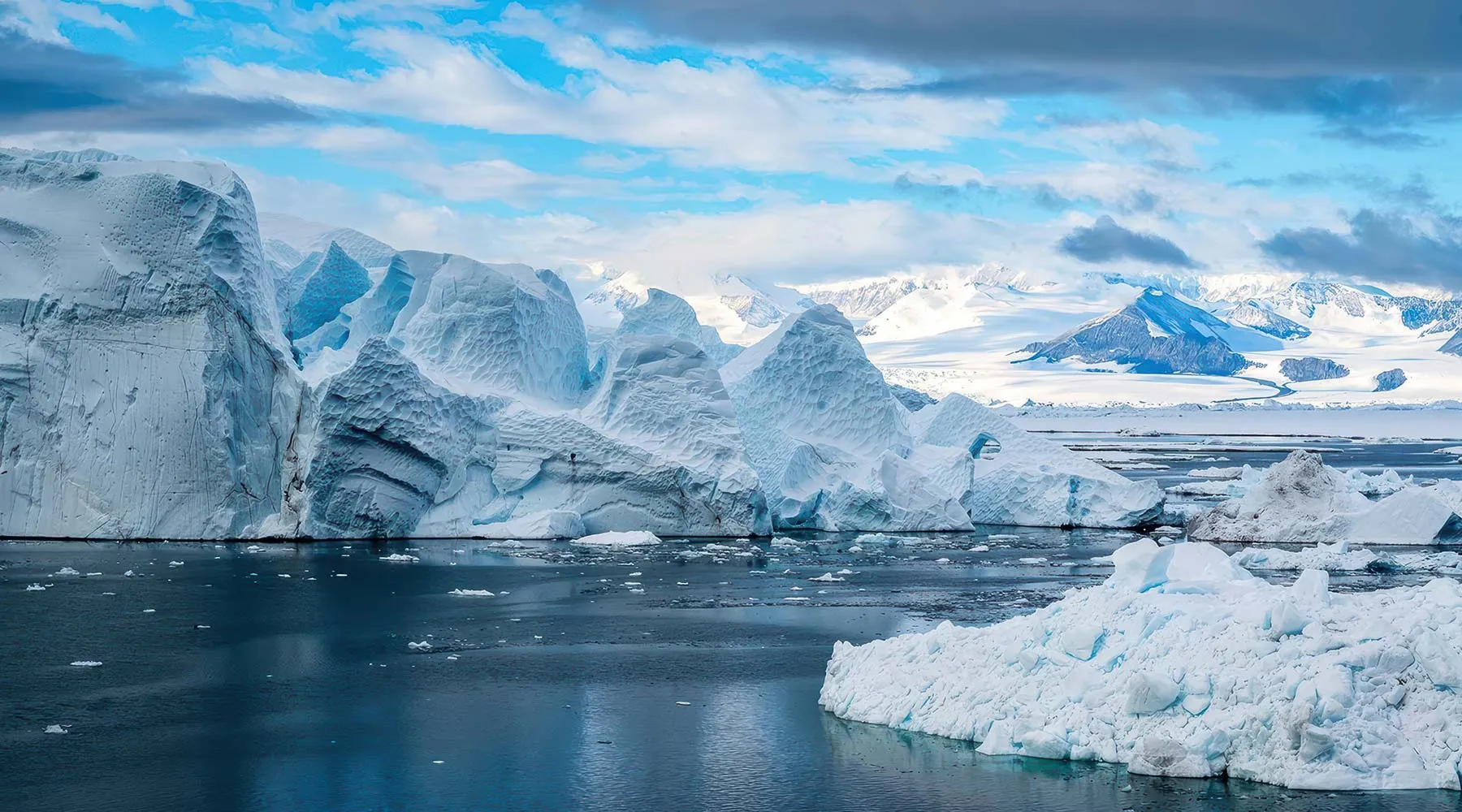 Distant sun behind an Antarctic glacier