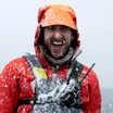 Will Abbott laughing in falling snow on a zodiac in Antarctica